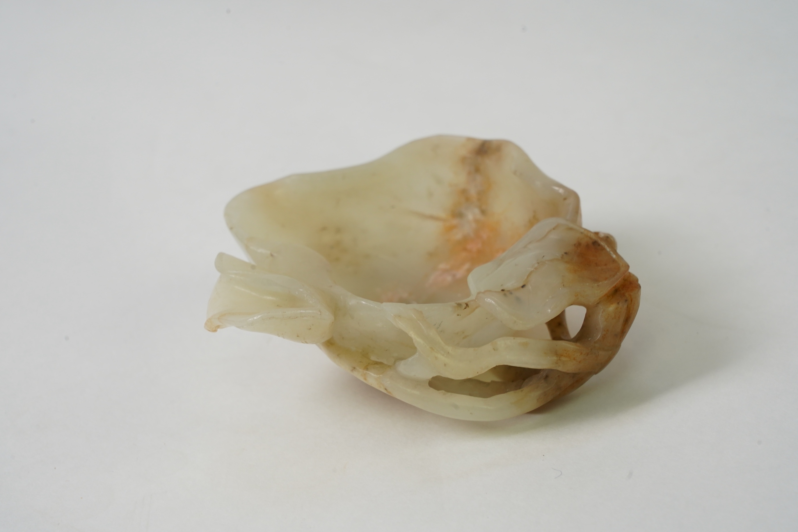A Chinese pale celadon and russet jade brushwasher, Ming dynasty, 16th/17th century
